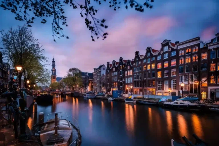 Tranquil Amsterdam canal with arched stone bridges, parked bicycles, and canal houses